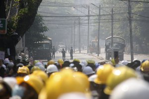 Protesters monitoring Police movement during an anti-coup protest behind on a blocked road in Mandalay, Myanmar, Tuesday, March 2, 2021. Police in Myanmar’s biggest city fired tear gas Monday at defiant crowds who returned to the streets to protest last month's coup, despite reports that security forces had killed at least 18 people a day earlier. (AP Photo)