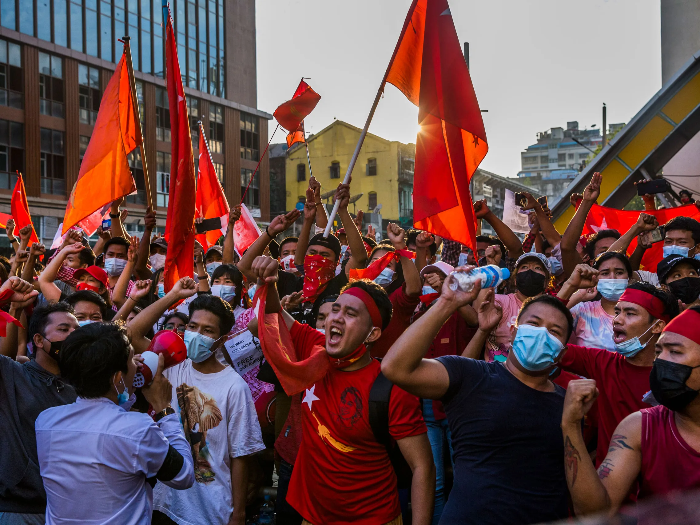 Protestors hold flags and march in Myanmar