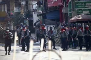 Armed police stand guard on a major street to preven anti-coup demonstration in Yangon,  Myanmar, Friday, March 5, 2021. Footage of a brutal crackdown on protests against a coup in Myanmar has unleashed outrage and calls for a stronger international response.  (AP Photo)