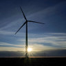 A wind turbine is silhouetted against the rising sun near Spearville, Kansas, one of the states suing US President Joe biden over his first executive order.