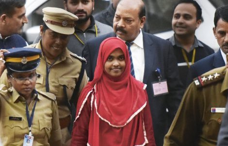 Hadiya, in the red dress, appears at the Supreme Court in New Delhi to defend her marriage to her Muslim husband Shafin in one of India’s alleged ‘love jihad’ cases. Vipin Kumar/Hindustan Times via Getty