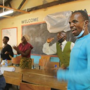 Malawi Citizens’ Assembly member Daudi Amidu, a merchant trader, dances alongside fellow participants as they take a pause from considering ways to improve local spending rules in Salima South, Lake Malawi. MADALITSO BANDA/ALL HANDS ON