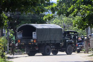 A police vehicle is parked at a road in South Okkalapa township to block anti-coup protesters' gathering in Yangon, Myanmar, Friday, April 9, 2021.