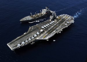 Nimitz-class aircraft carrier USS Theodore Roosevelt steams alongside the Military Sealift Command fleet replenishment oiler USNS John Lenthall