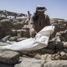 A worker covers skeletal remains found at the site of a 3000 year-old lost city in Luxor, Egypt. 