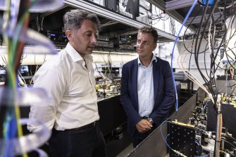 Professor Michael Biercuk and NSW Transport Minister inspect a quantum computer at the University of Sydney.