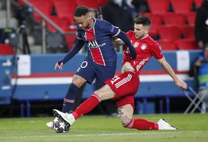 PSG's Neymar, left, and Bayern's Lucas Hernandez challenge for the ball during the Champions League, second leg, quarterfinal soccer match