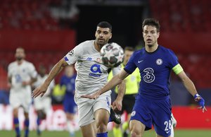 Chelsea's Cesar Azpilicueta, right, duels for the ball with Porto's Mehdi Taremi during the Champions League quarter final