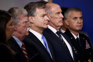 FBI Director Christopher Wray listens during the daily press briefing at the White House