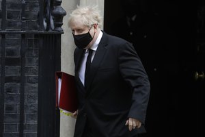 Britain's Prime Minister Boris Johnson leaves 10 Downing Street to attend the weekly session of Prime Ministers Questions in Parliament in London, Wednesday, April 14, 2021. (AP Photo/Kirsty Wigglesworth)