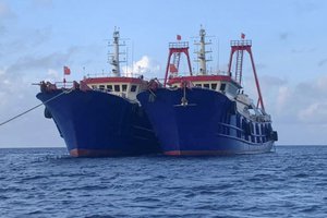 This photo provided by the National Task Force-Philippine West Sea shows Chinese ships moored on the Whitsun reef in the South China Sea on March 27, 2021