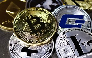 Various cryptocurrencies coins on table - Bitcoin, Litecoin, Dogecoin and Etherrum