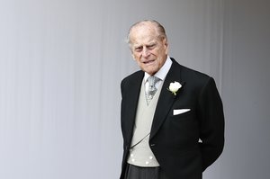 FILE - In this Friday, Oct. 12, 2018 file photo, Britain's Prince Philip waits for the bridal procession following the wedding of Princess Eugenie of York and Jack Brooksbank in St George's Chapel, Windsor Castle, near London, England.