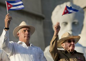 Cuba's President Miguel Diaz-Canel, left, and former Cuban President Raul Castro wave Cuban flags