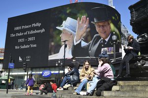 Images of Britain’s Prince Philip are displayed on a giant screen at Piccadilly Circus, London Saturday, April 17, 2021. Prince Philip, husband of Queen Elizabeth II, died Friday April 9 aged 99