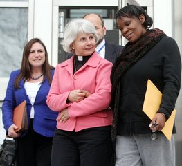 Beatrice Munyenyezi, right, leaves Federal Court Thursday April 12, 2012 in Concord, N.H.