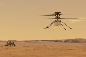 This illustration made available by NASA depicts the Ingenuity helicopter on Mars which was attached to the bottom of the Perseverance rover, background left.