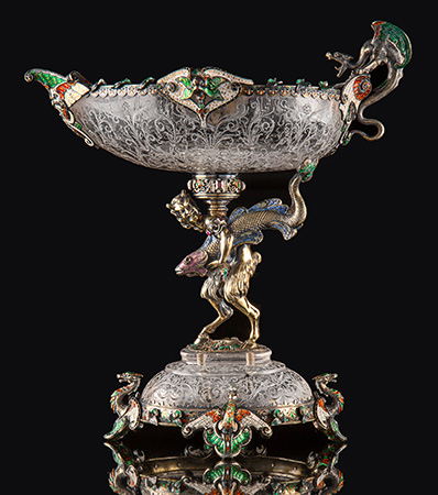 A Hermann Ratzersdorfer Gem-Set, Partial Gilt, and Enameled Silver-Mounted and Engraved Rock Crystal Figural Tazza