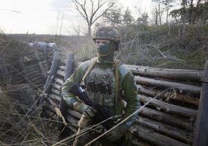 A Ukrainian soldier is seen at fighting positions on the line of separation from pro-Russian rebels near Luhansk, Ukraine, Friday, April 16, 2021.