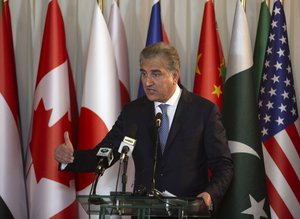 Pakistani Foreign Minister Shah Mahmood Qureshi addresses a news conference with U.N. Secretary-General Antonio Guterres at the Foreign Ministry in Islamabad, Pakistan, Sunday, Feb. 16, 2020