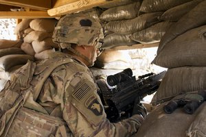 In this Sept. 8, 2016 photo, a U.S. Army soldier guards an overwatch position at Camp Swift, northern Iraq. U.S. troops will be engaged more closely than ever in fighting against Islamic State militants as they back Iraqi forces in the long-anticipated assault on Mosul. The assault caps an increasing American role in Iraq over the past two years, with nearly 6,000 US troops on the ground, including special forces in combat on the front-lines. (AP Photo/Susannah George)