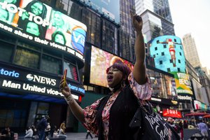 AniYa A motions as she walks through Times Square in New York, while talking on her cell phone after a Minnesota jury found Former Minneapolis police officer Derek Chauvin guilty of murder and manslaughter in the death of George Floyd, Tuesday, April 20, 2021.