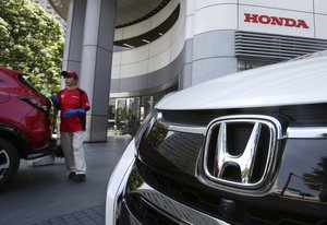 A employee of Honda cleans up a Honda Car at headquarters of Honda Motor Co.in Tokyo, Tuesday, July 31, 2018.