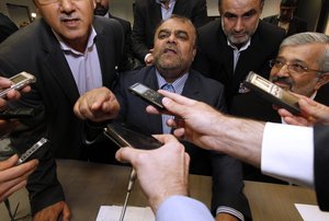 Iran's Minister of Petroleum Rostam Ghasemi, center, gestures as he speaks to journalists prior to the start of the meeting of the Organization of the Petroleum Exporting Countries, OPEC, at their headquarters in Vienna, Austria, on Thursday, June 14, 2012.