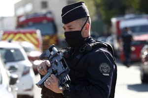 Police officer blocks the access next to the Police station in Rambouillet, south west of Paris, Friday, April 23, 2021.