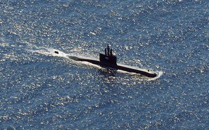 In this aerial photo taken from a maritime patrol aircraft of 800 Air Squadron of the 2nd Air Wing of Naval Aviation Center (PUSPENERBAL), the Indonesian Navy submarine KRI Alugoro sails during a search for KRI Nanggala, another submarine that went missing while participating in a training exercise on Wednesday, in the waters off Bali Island, Indonesia, Thursday, April 22, 2021.