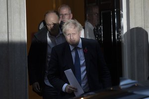 British Prime Minister Boris Johnson and his advisor Dominic Cummings, left, leave 10 Downing Street in London, and get in a car together to go to the Houses of Parliament, Monday, Oct. 28, 2019