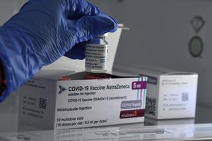 A health worker takes a vial of AstraZeneca Covid-19 from a freezer in Podgorica on April 14, 2021.