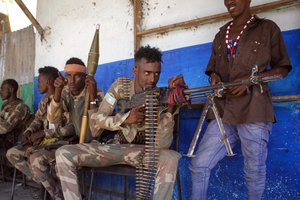 Military forces supporting anti-government opposition groups take position on a street in the Fagah area of Mogadishu, Somalia Sunday, April 25, 2021