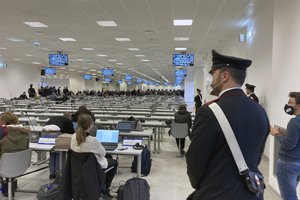 A Carabinieri police officer wearing a face mask to curb the spread of COVID-19 stands guard during the first hearing of a maxi-trial against more than 300 defendants of the ‘ndrangheta crime syndicate, in a specially constructed bunker near the Calabrian town of Lamezia Terme, southern Italy, Wednesday, Jan. 13, 2021.