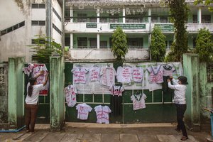 Activists and anti-coup protesters hang student uniforms on the wall of a school during a demonstration against the re-opening of the school by the government in Yangon, Myanmar, Tuesday, April 27, 2021.