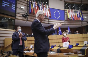 Head of the Task Force for Relations with the UK Michel Barnier, center, and European Commission President Ursula von der Leyen, right, attend a debate on the EU-UK trade and cooperation agreement during the second day of a plenary session at the European Parliament in Brussels, Tuesday, April 27, 2021.