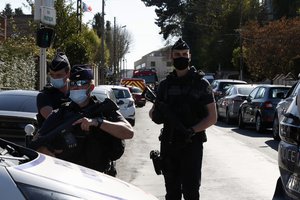 Police officers block the access next to the Police station in Rambouillet, south west of Paris, Friday, April 23, 2021. A French police officer was stabbed to death inside her police station Friday near the famed historic Rambouillet chateau, and her attacker was shot and killed by officers at the scene, authorities said.