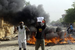 Two men protest on a street in N'Djamena, Chad, Tuesday, April 27, 2021