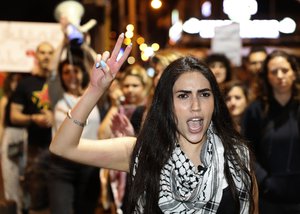 An Arab woman shouts slogans against Jewish nationalist religious groups that are buying up property in the Arab neighborhood of Jaffa in Tel Aviv, Israel, Saturday, April 24, 2021. Jaffa, the historic core of the greater Tel Aviv metropolis, is home to around 20,000 Arab residents, remnants of the Palestinian population of the city from before Israel’s creation in 1948. The district has undergone extensive gentrification in recent decades, accelerated in the past several years as real estate prices in Israel have skyrocketed to meet surging demand. The wealthy Tel Avivis’ push southward into Jaffa has come at the expense of Jaffa’s largely impoverished and working class Arab residents, adding an ethnic element to an economic phenomenon familiar in other global cities. (AP Photo/Ariel Schalit)