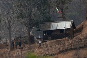 Myanmar soldiers stand at a small army camp along the river bank near the border of Myanmar and Thailand on Tuesday March 30, 2021. The weekend strikes by the Myanmar military, which sent ethnic Karen people seeking safety in Thailand, represented another escalation in the violent crackdown by Myanmar’s junta on protests of its Feb. 1 takeover.(AP Photo/Sakchai Lalit)