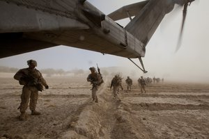 File -  U.S. Marines with Bravo Company, 1st Battalion, 9th Marine Regiment run toward a CH-53E Super Stallion helicopter assigned to Marine Heavy Helicopter Squadron (HMH) 462 in Gurjat, Helmand province, Afghanistan, Oct. 28, 2013.