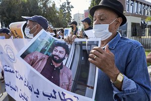 Journalist and activist Omar Radi for his first hearing is supported by activist as he protest in front of the Casablanca Courthouse, in Casablanca, Morocco, Tuesday, Sept, 2020.