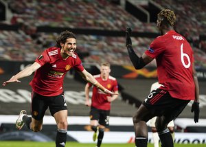 Edinson Cavani, left, celebrates after scoring his side's third goal during the Europa League semi final