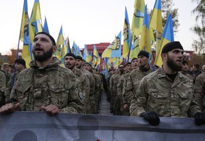 Fighters from the Azov volunteer battalion shout slogans during the march marking the 72nd anniversary of the Ukrainian Insurgent Army in Kiev, Ukraine, Tuesday, Oct. 14, 2014.