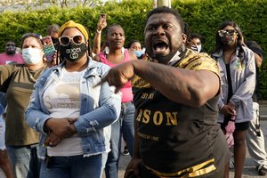 File - People gather outside the municipal building after at least one Pasquotank County Sheriff's deputy shot and killed a Black man while executing a search warrant, the sheriff's office said, Wednesday, April 21, 2021, in Elizabeth City, North Carolina.