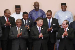 In this Sept. 3, 2018, file photo, Chinese President Xi Jinping, front center, South African President Cyril Ramaphosa, front row left, Egyptian President Abdel Fattah al-Sisi, front right, Kenya's President Uhuru Kenyatta, second row left, Togo's President Faure Gnassingbe, second row center, Malawi's President Arthur Peter Mutharika, third row right, Sierra Leone President Julius Maada Bio, third row left, Liberian President George Weah, third row center, with other African leaders clap during a group photo session at the Forum on China-Africa Cooperation (FOCAC) 2018 Beijing Summit in Beijing.