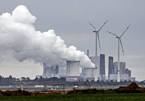 In this Sept.25, 2020 file photo a coal fired power station steams near the Garzweiler surface coal mine in Germany.