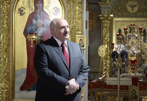 Belarusian President Alexander Lukashenko, left, attends the Orthodox Easter service in the town of Turov, some 270 km (167 miles) south of Minsk, Belarus, Sunday, May 2, 2021.