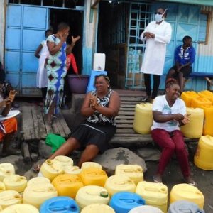 Health workers demonstrate handwashing techniques to Mukuru community members. Photo: Victoria Nthenge