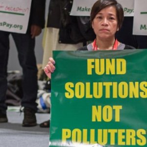 Make them pay action at COP25, Madrid. Credit: Victor Barro/FoEI